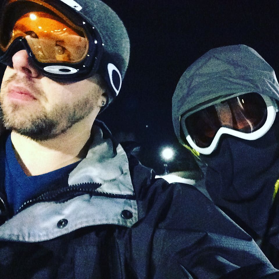 A skier and a ninja get off a chair lift. Note: it’s 50 degrees, he is dressed for the Arctic.