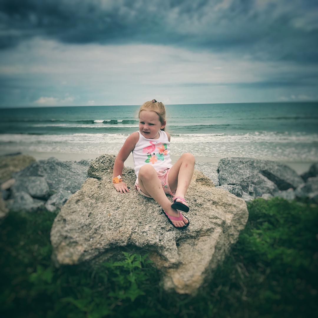 Just a girl, a rock and the sea.